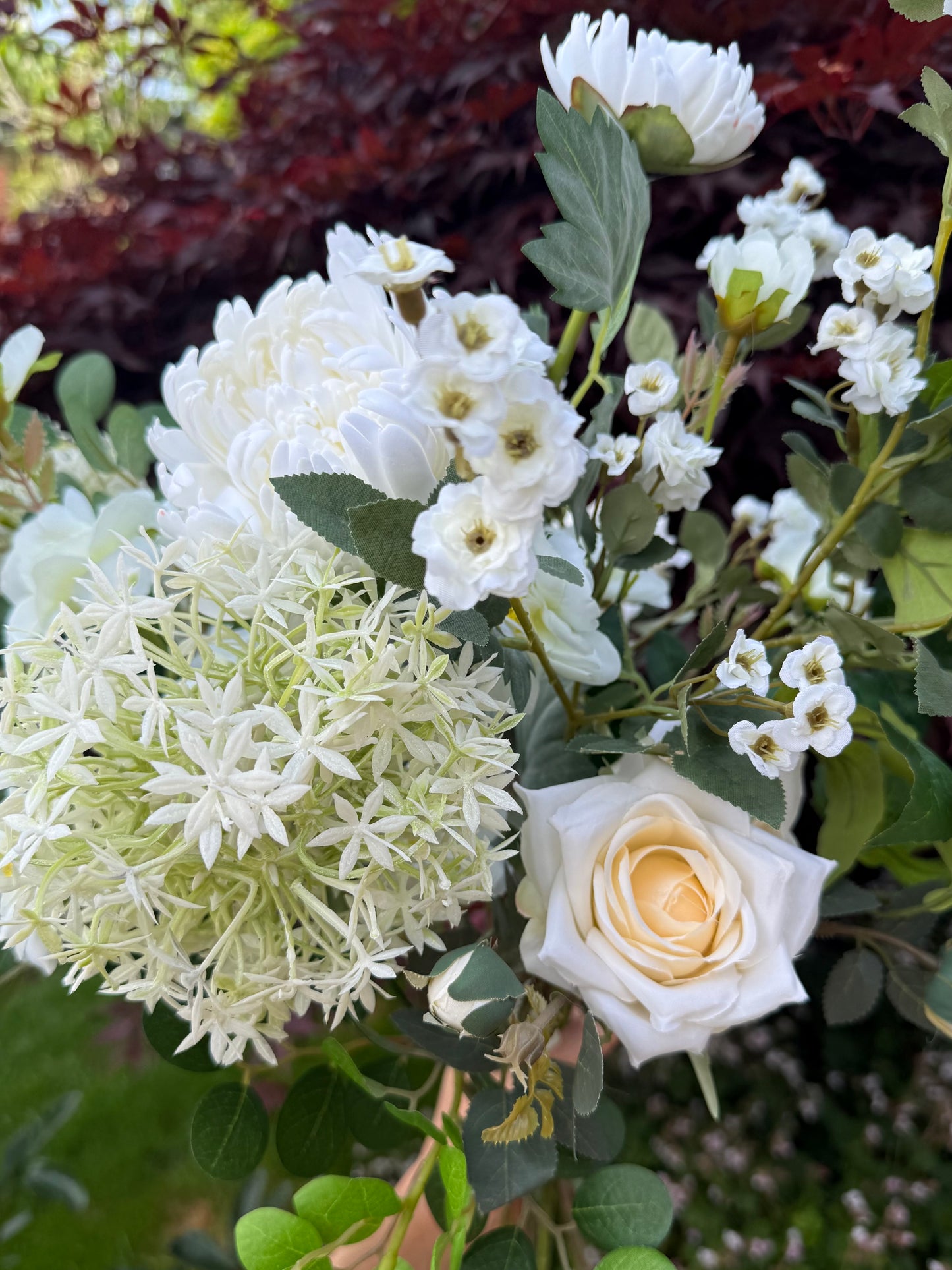 Bouquet of white and green flowers with a yellow rose.