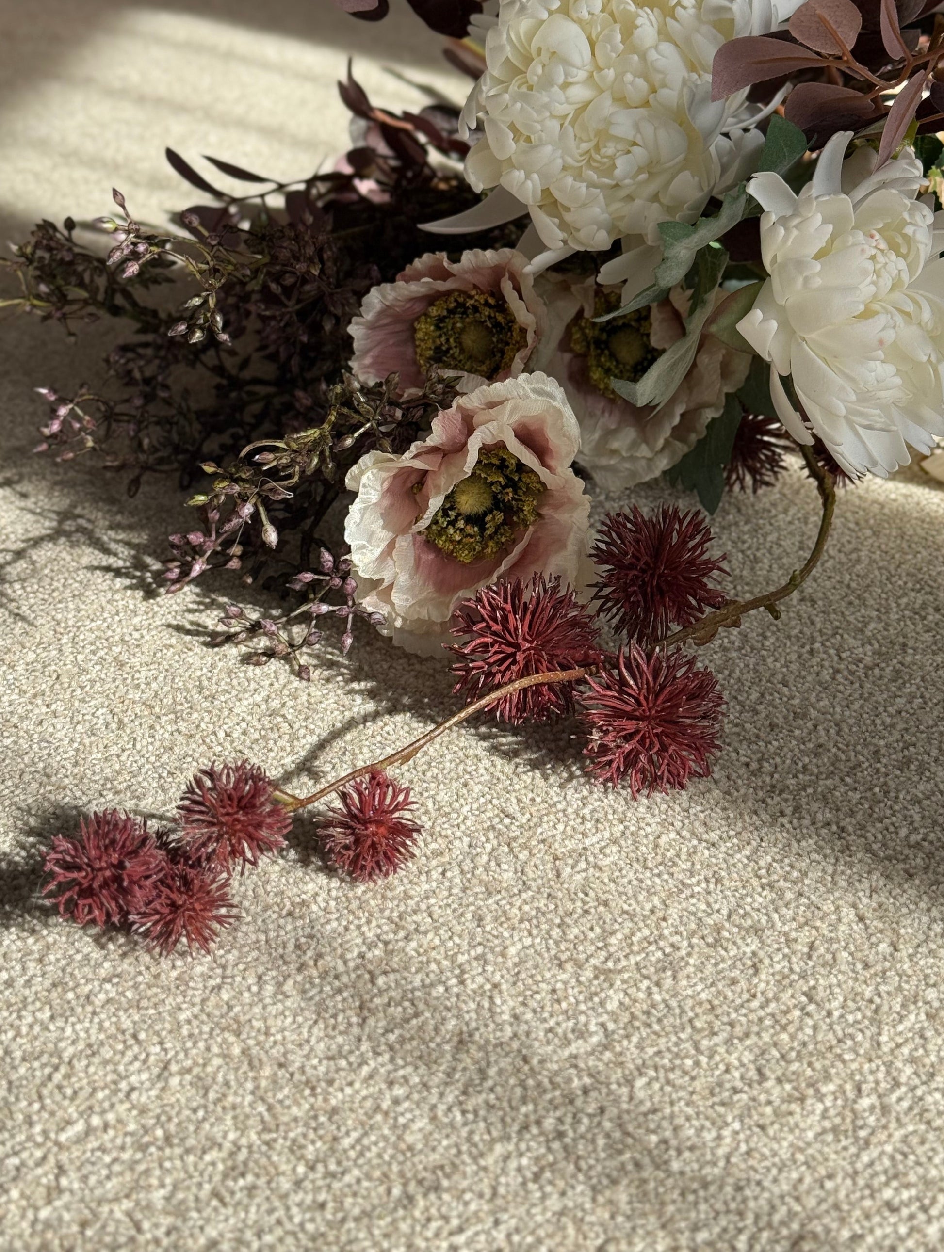 Artificial flower arrangement on a textured surface