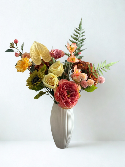 Floral arrangement in a white vase on a light background