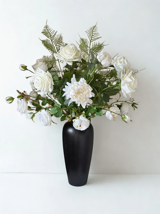 Bouquet of white flowers in a black vase on a white background
