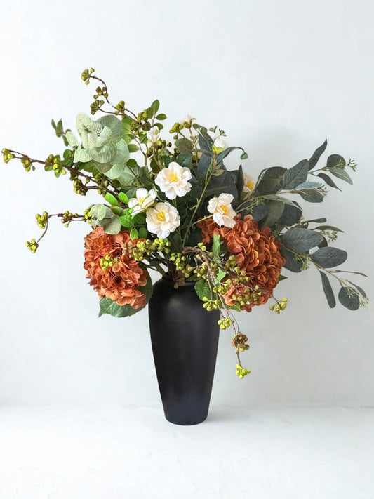 Realistic Artificial Floral arrangement in a black vase on a white background