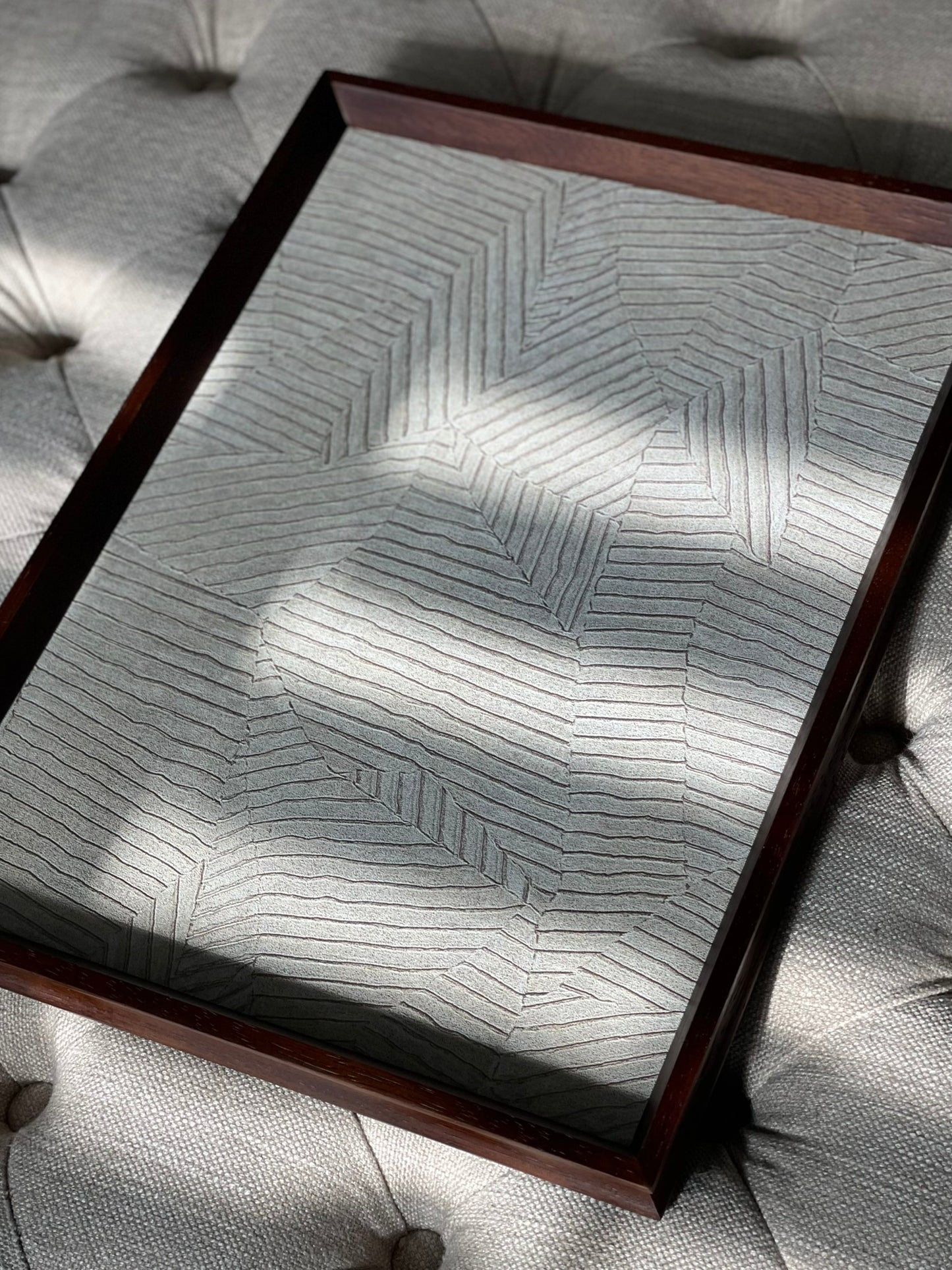 Decorative tray with geometric pattern on a textured surface