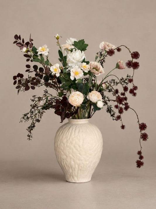 White vase with a bouquet of flowers on a beige background best artificial bouquets