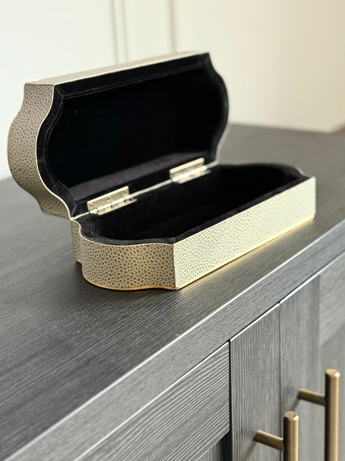 Decorative remote control box with a textured surface on a wooden surface