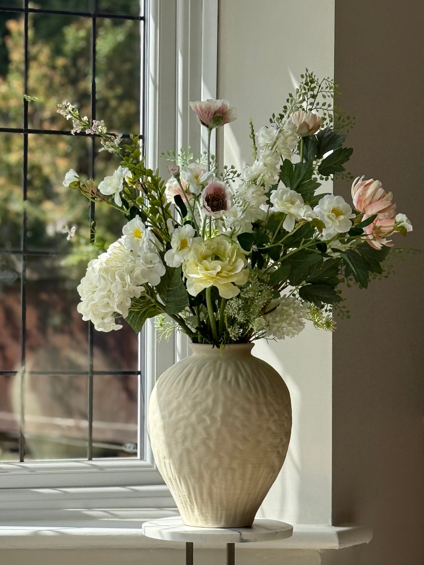 Vase with flowers on a windowsill