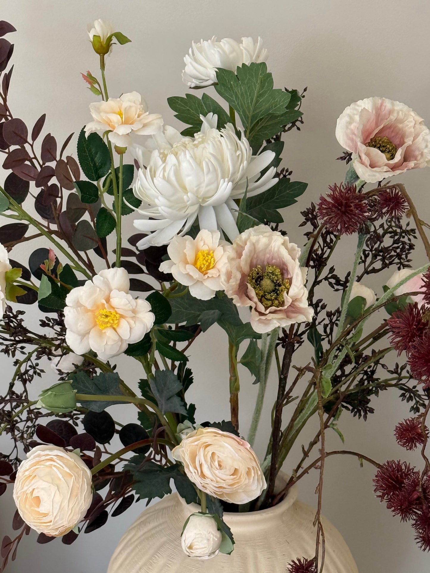 Bouquet of flowers with white, pink, and green colors on a neutral background